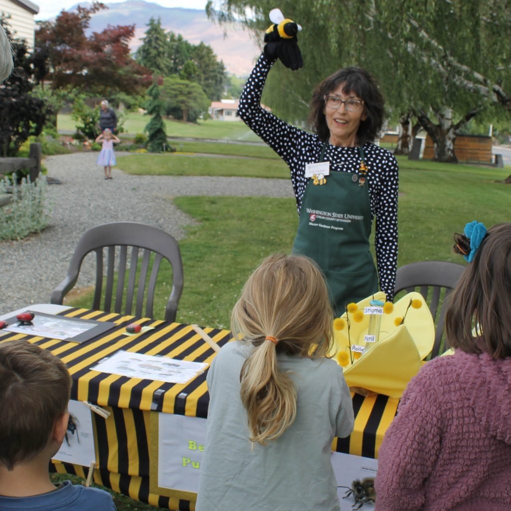 Extension Master Gardener teaching children about pollinators.